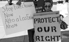 Carlos Parkins and Annie Mora stand up for housing rights at rally in Oakland. Photo: CJJC archives