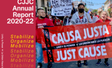 three people wearing red CJJC t-shirts holding a red, black and white Causa Justa :: Just Cause banner. Left side of the image is red with white and yellow lettering.
